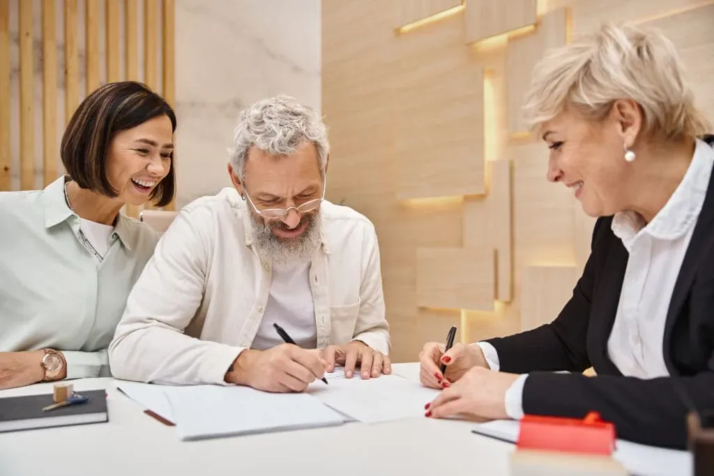 2 people signing paperwork