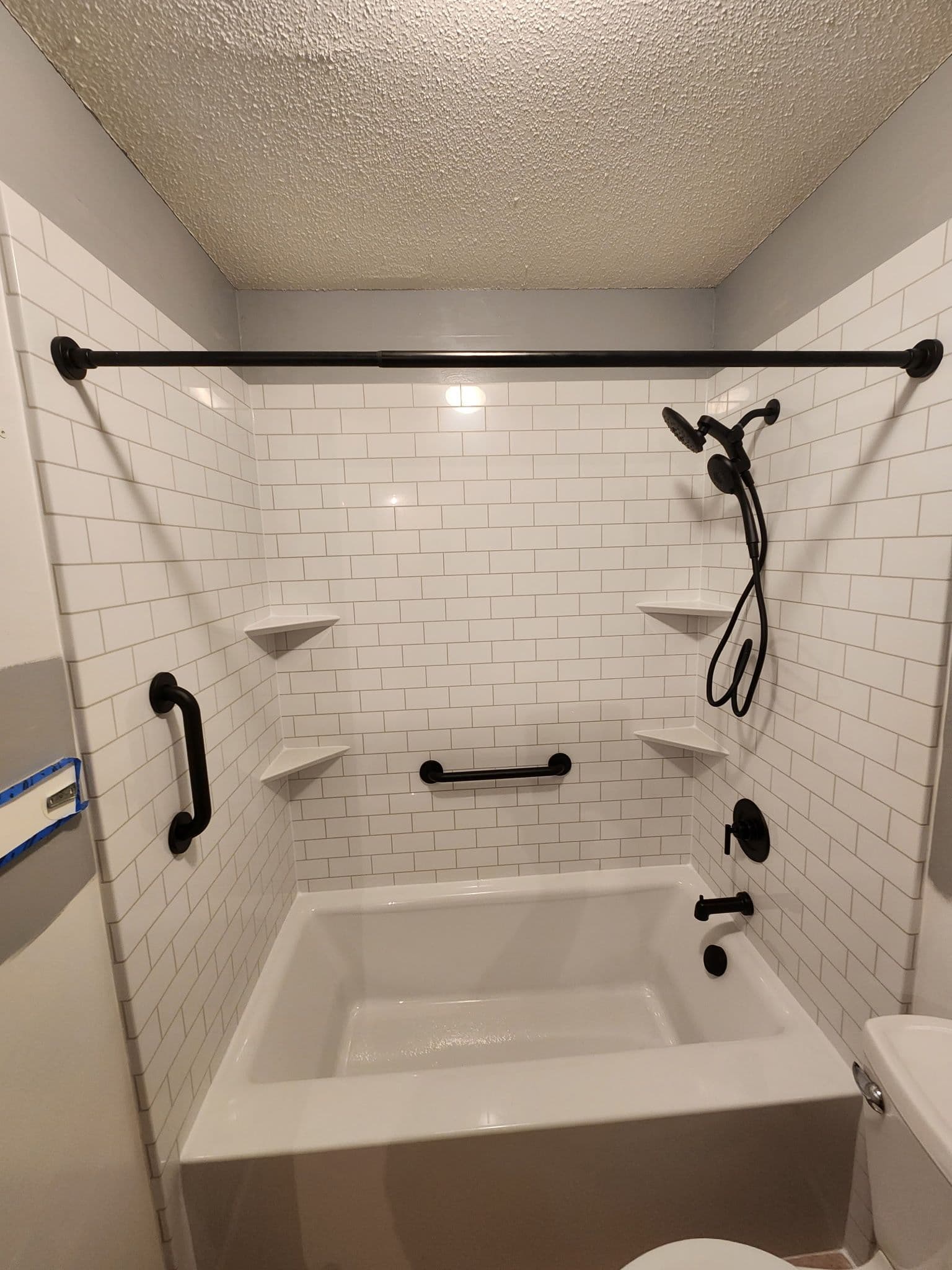 Bathtub remodel with black hardware